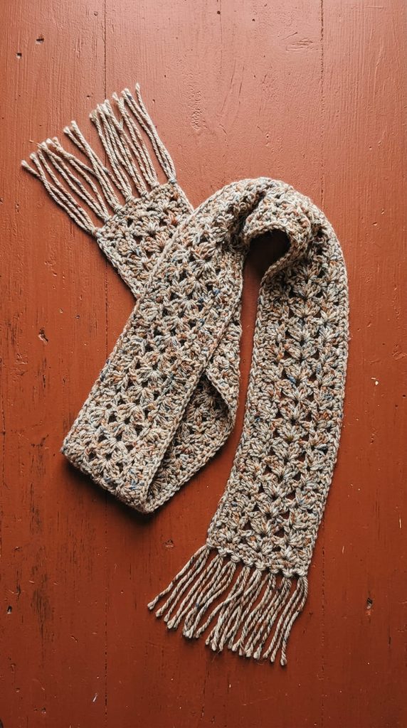 Lacy tweed yarn crochet scarf in a skinny silhouette