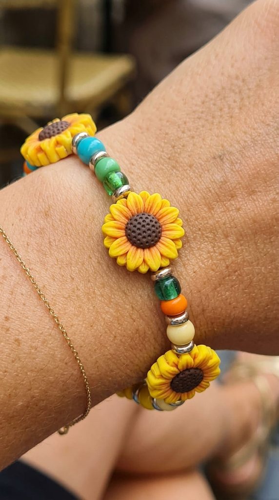 polymer clay sunflower beads on a beaded bracelet